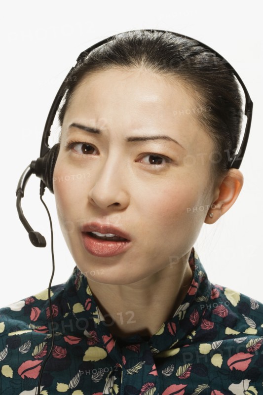Studio shot of Asian woman wearing headset