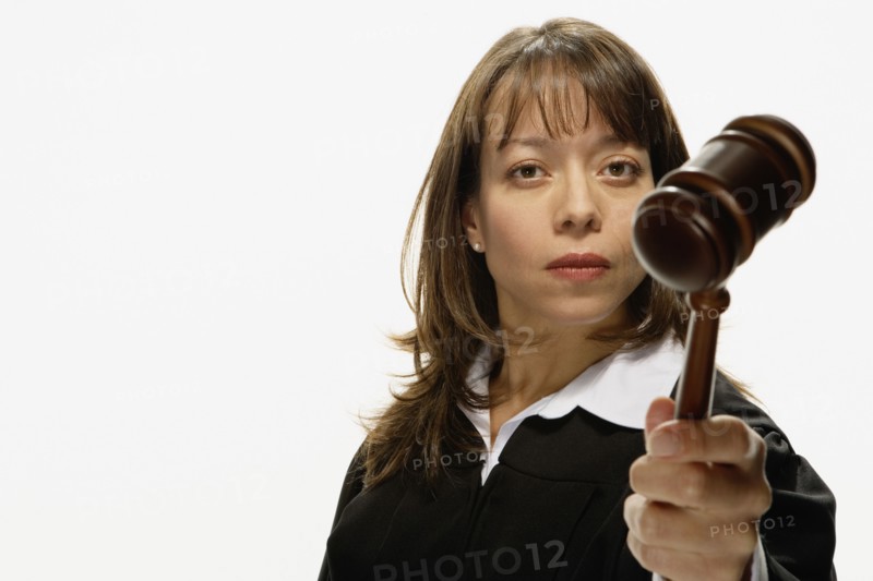 Studio shot of Hispanic female judge holding gavel