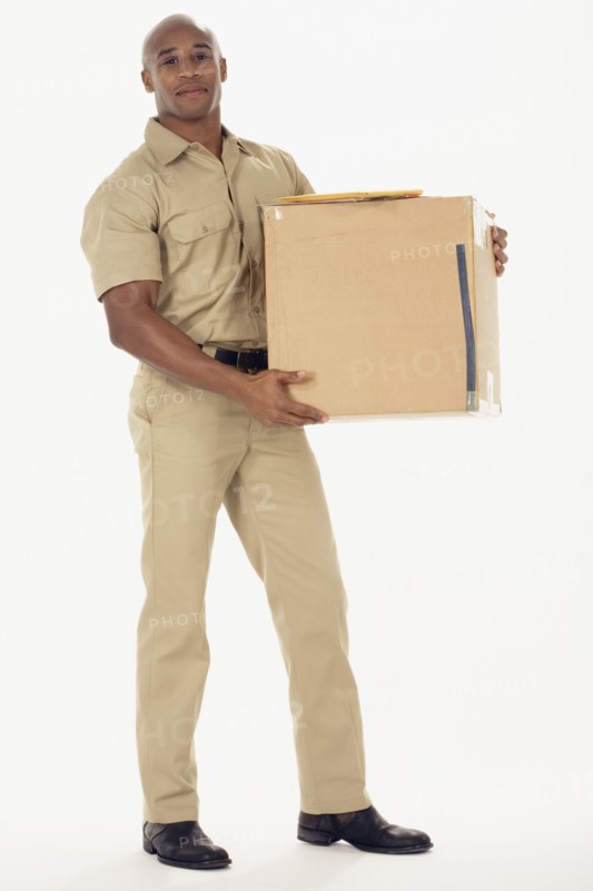 Studio shot of African delivery man with package