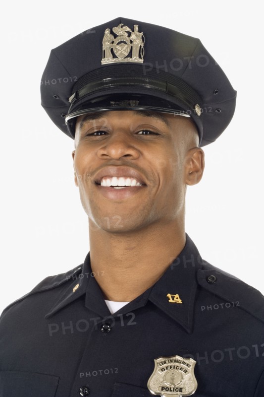 Studio shot of African male police officer smiling