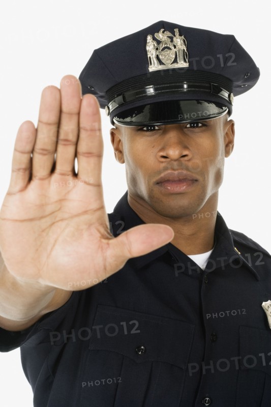 Studio shot of African male police officer