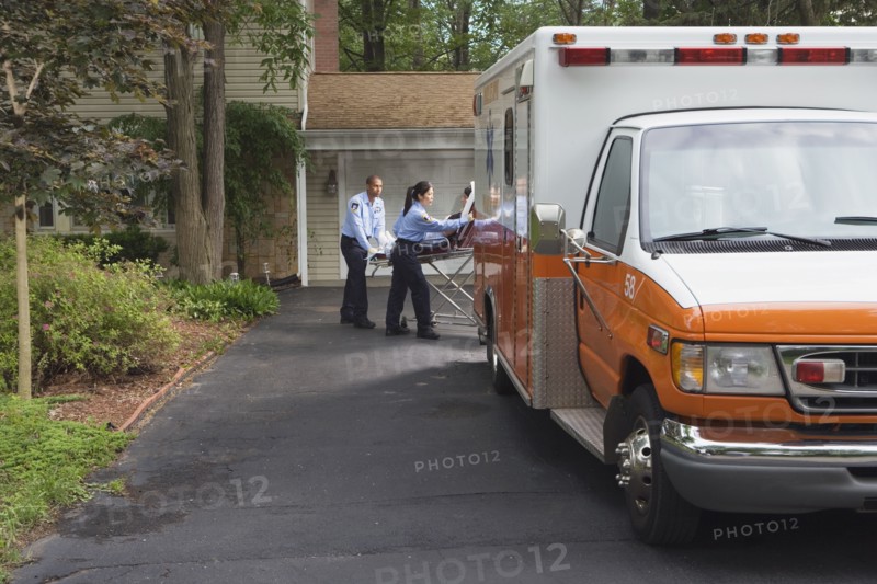 Paramedics putting person into ambulance