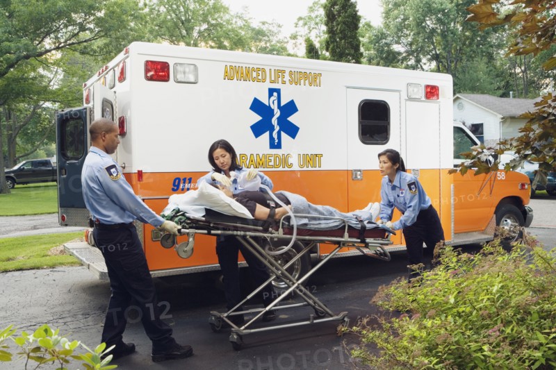 Paramedics putting woman into ambulance