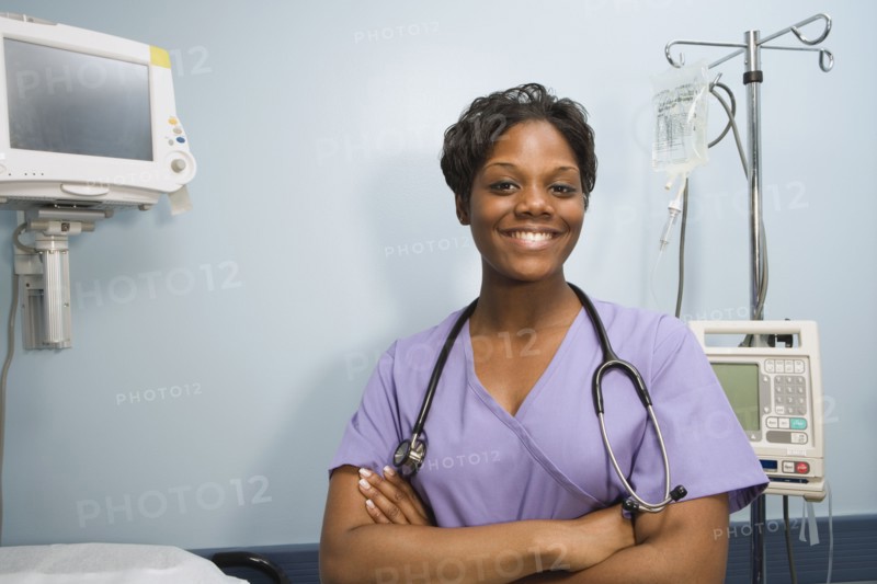African female nurse smiling in hospital room