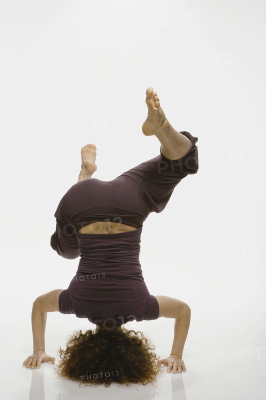 Mixed Race woman standing on head