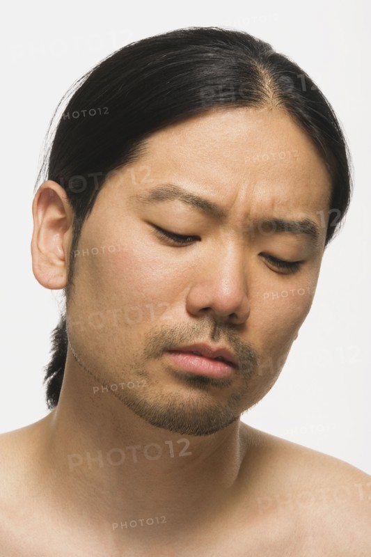 Asian man looking down