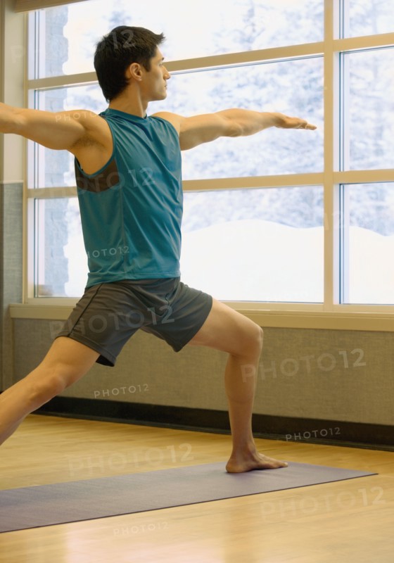 Asian man practicing yoga