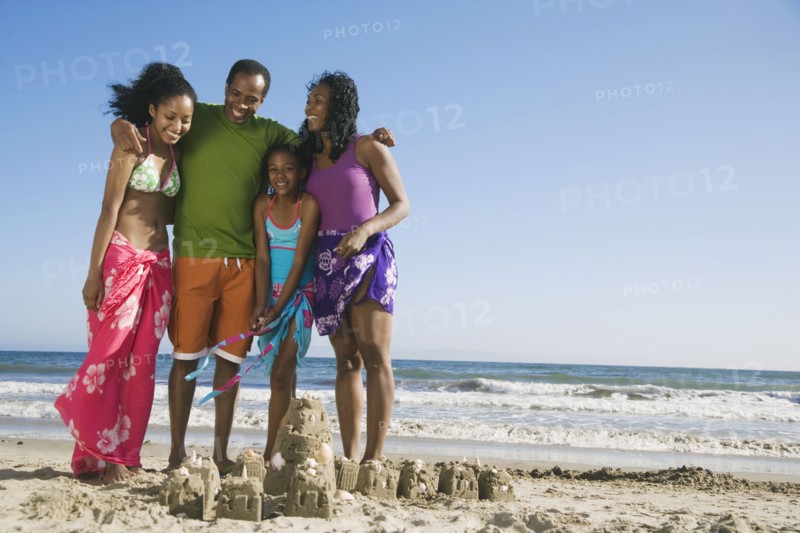 African family next to sand castle