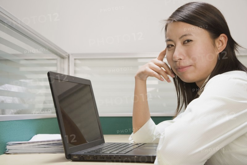 Chinese businesswoman using laptop at desk