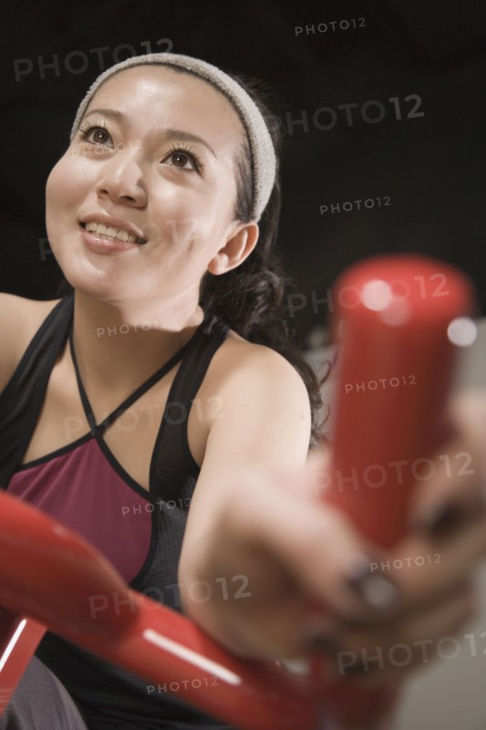 Chinese woman on exercise bicycle