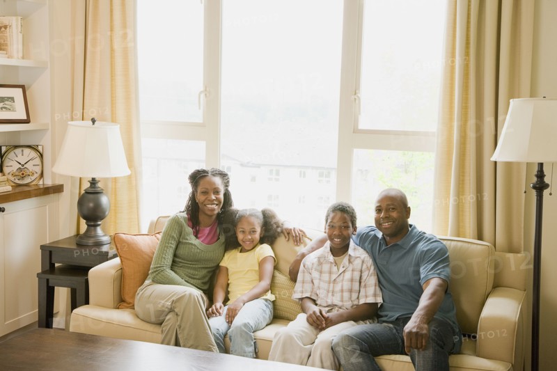 African American family sitting in living room