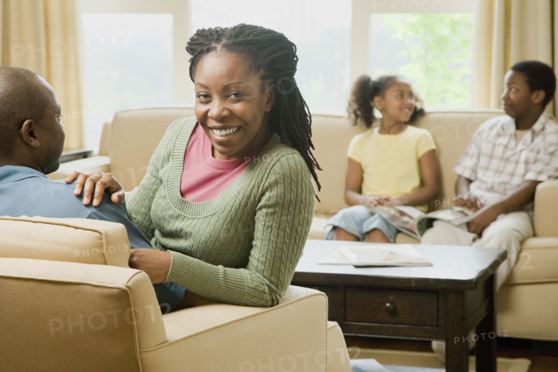 African American family sitting in living room