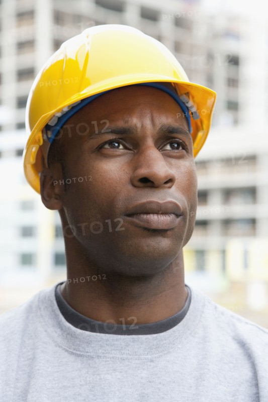 Black construction worker frowning