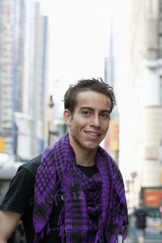 Hispanic man smiling on urban street