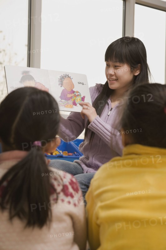 Chinese woman reading to children