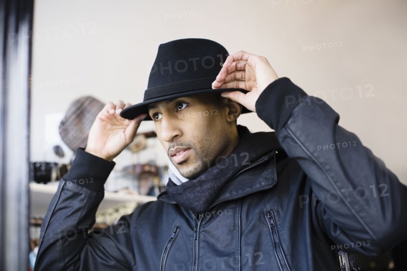 African American man adjusting fedora