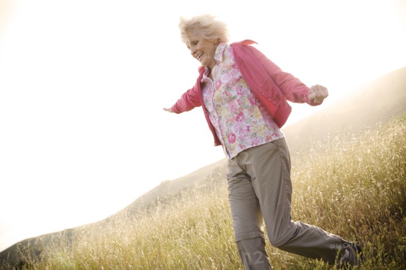 Caucasian woman running down hill