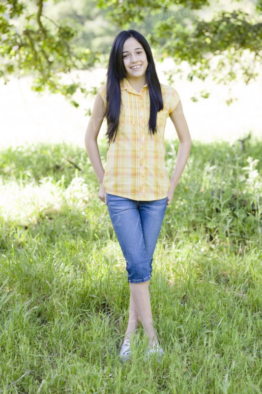 Hispanic girl standing in field