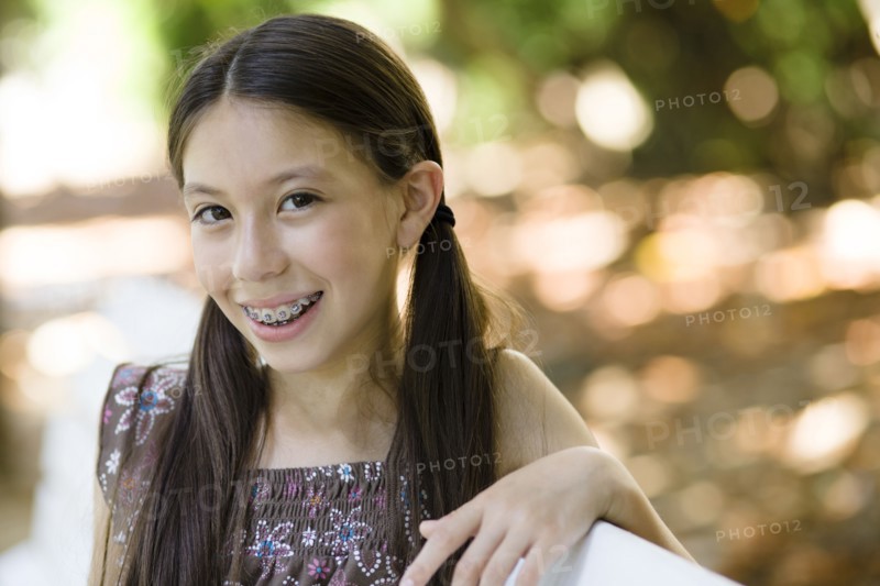 Smiling mixed race girl with braces