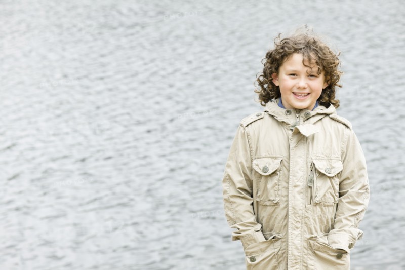 Smiling Caucasian boy with hands in pockets
