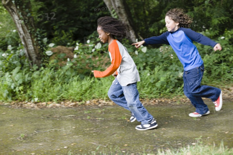 Boys playing tag in the park