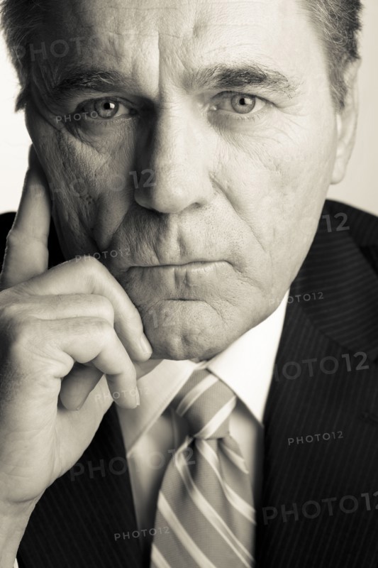 Serious Caucasian businessman with head in hands