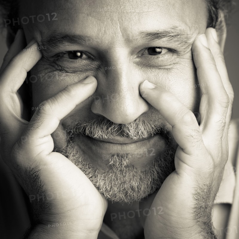 Middle Eastern man with head in hands