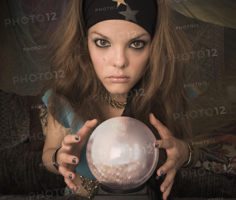 Woman dressed at fortune teller with crystal ball