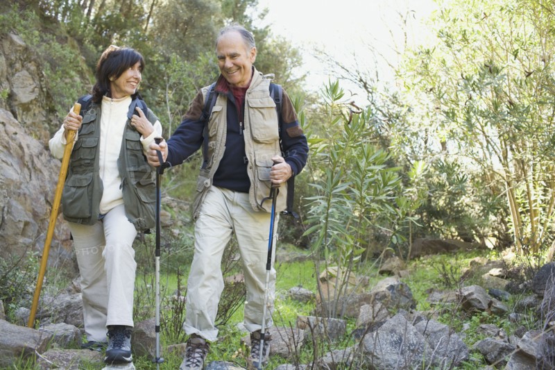 Senior couple hiking with poles