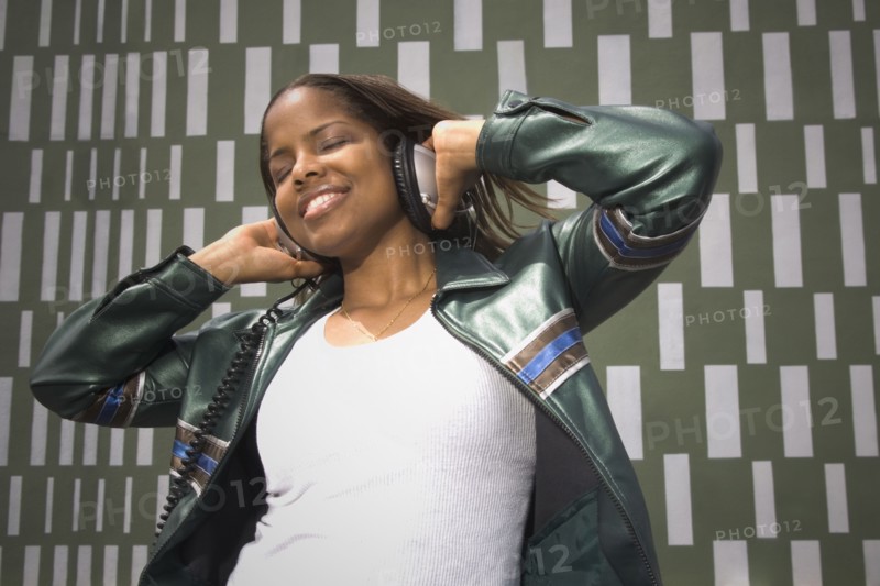 African woman listening to music on headphones