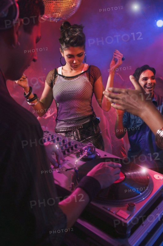 Hispanic dj playing at nightclub