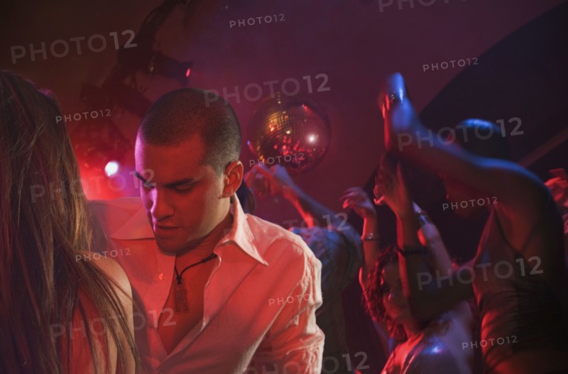 Multi-ethnic people dancing at nightclub