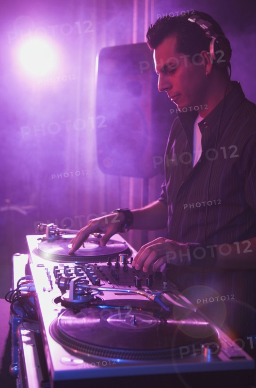 Hispanic dj playing at nightclub