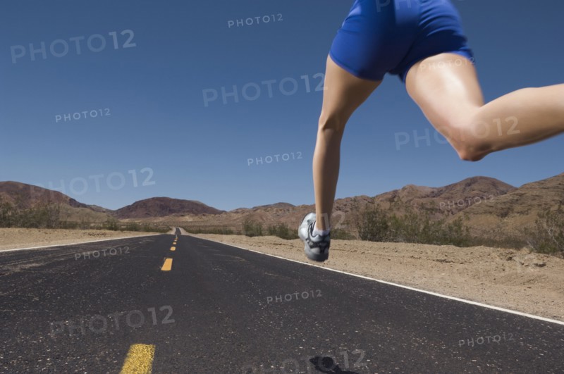 Mixed Race woman running on road