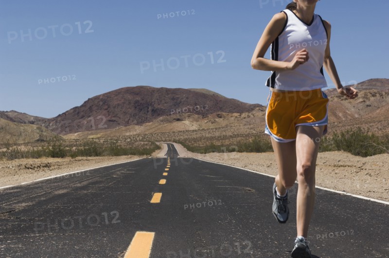 Mixed Race female runner on road