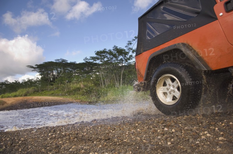 4x4 driving through water on remote road
