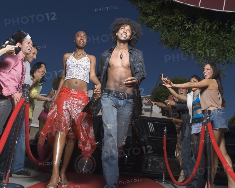 African couple walking on red carpet