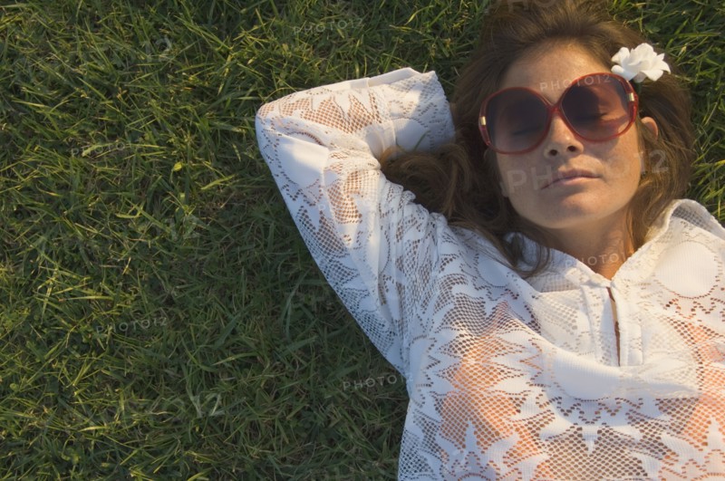High angle view of woman sleeping in grass