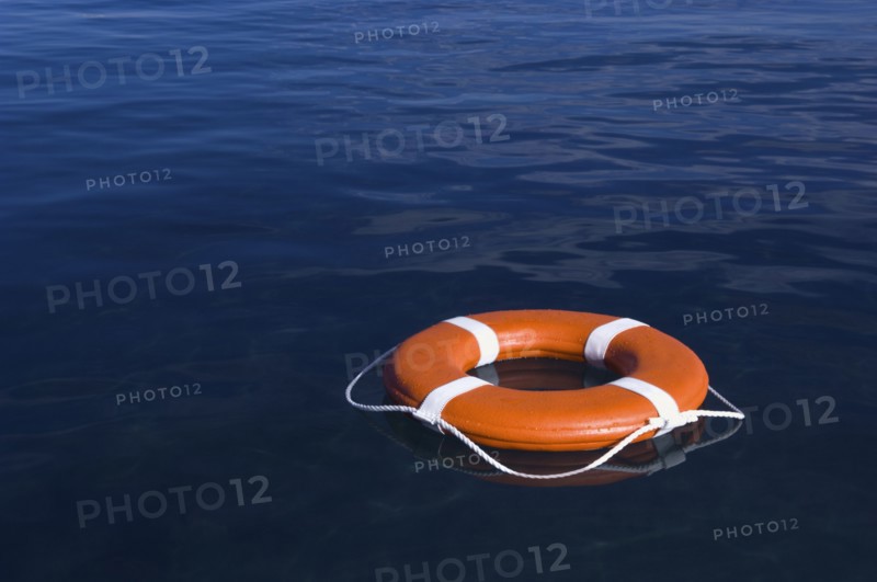 Round life preserver floating in water