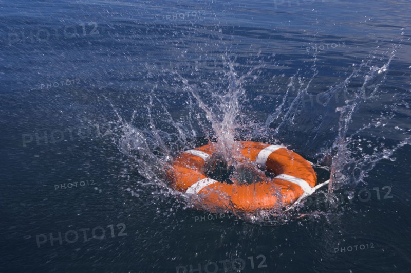 Round life preserver splashing into water