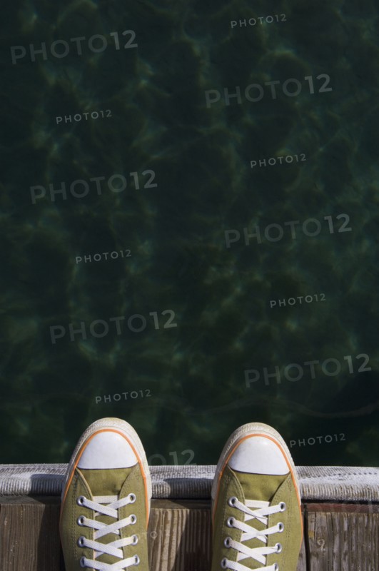 Sneakers on dock over water