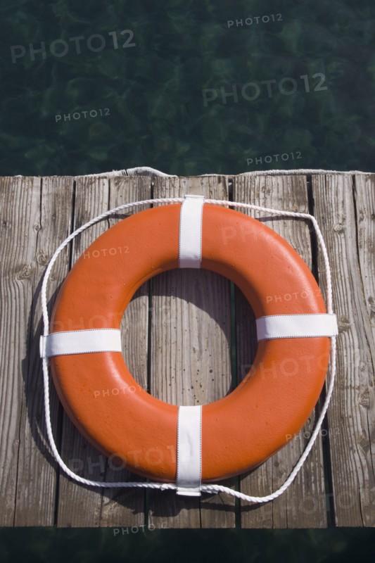 Round life preserver on wooden dock