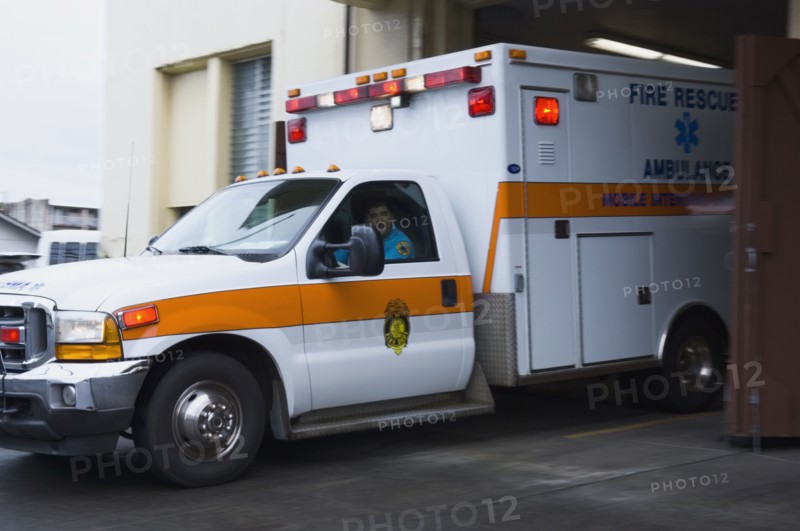 Asian male paramedic driving ambulance