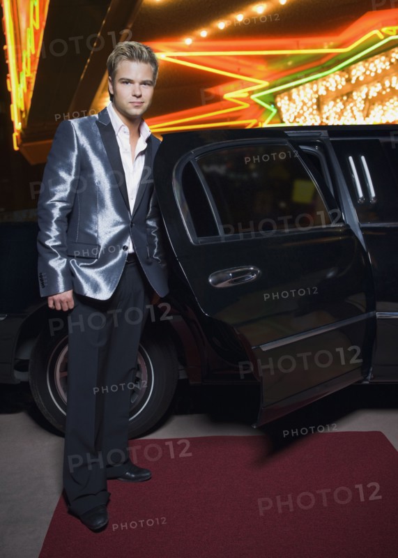 German man standing by limousine outside nightclub