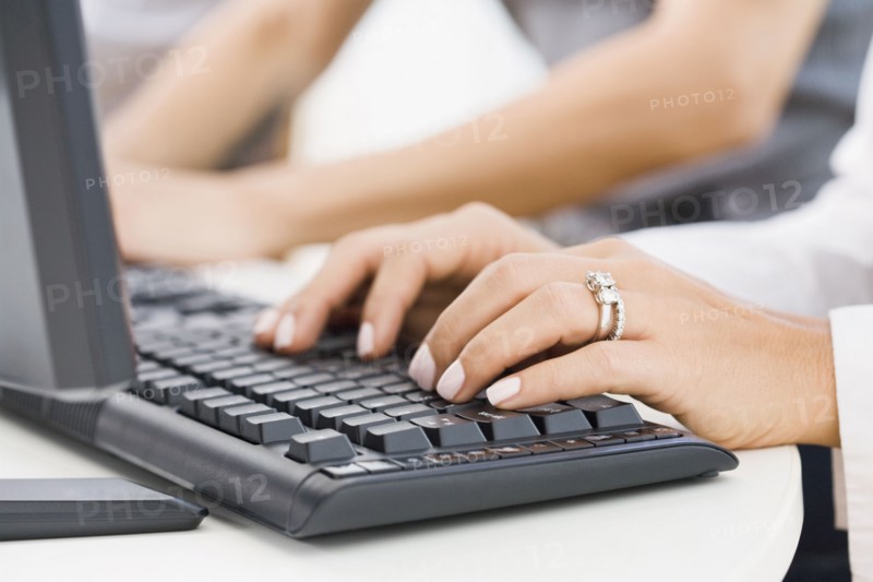 Hispanic woman typing on keyboard