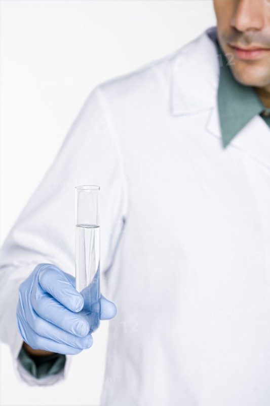 Hispanic scientist holding test tube full of water