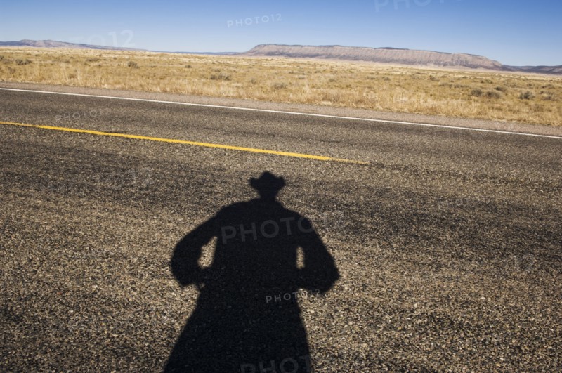 Shadow of cowboy on remote highway