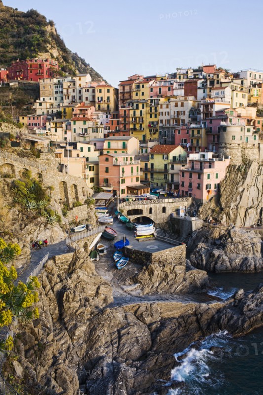 Houses on cliff face near ocean