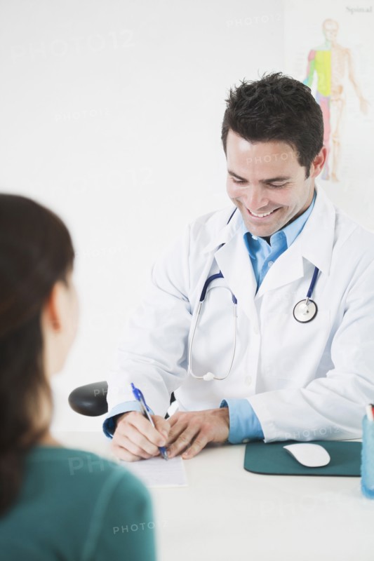 Doctor sitting at desk with patient