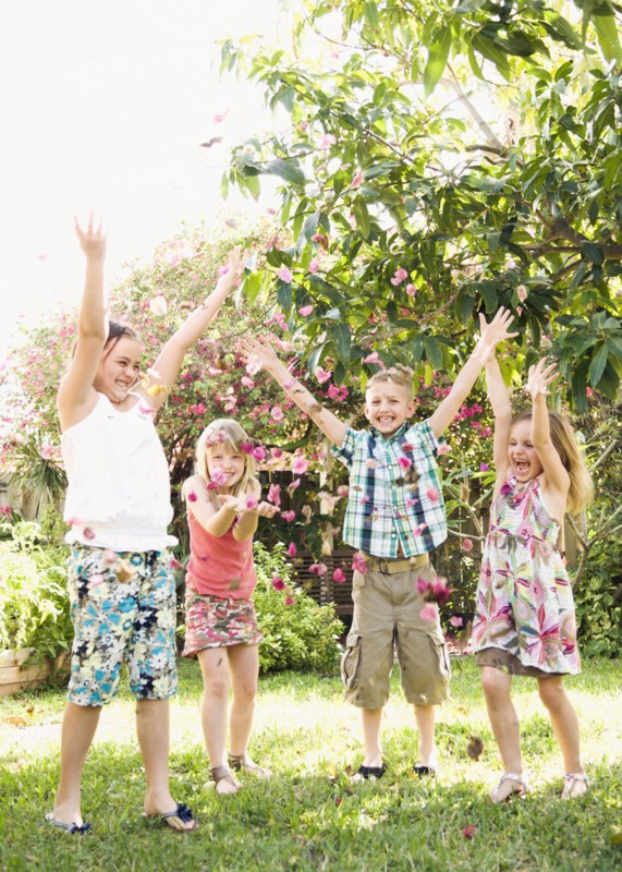 Caucasian children playing in garden